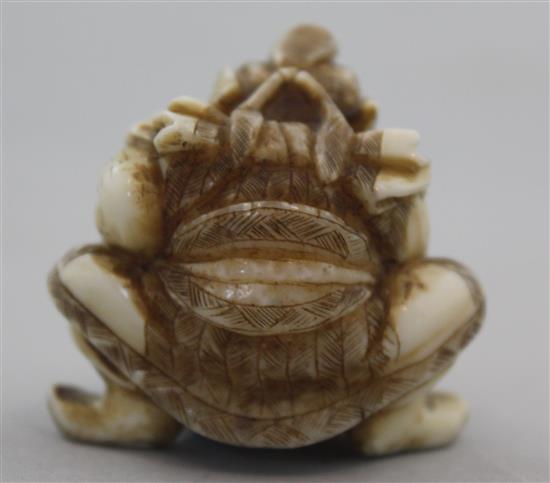 A Japanese walrus ivory netsuke of Shoki crushing two oni, signed Gyokuzan, Meiji period, 3.8cm